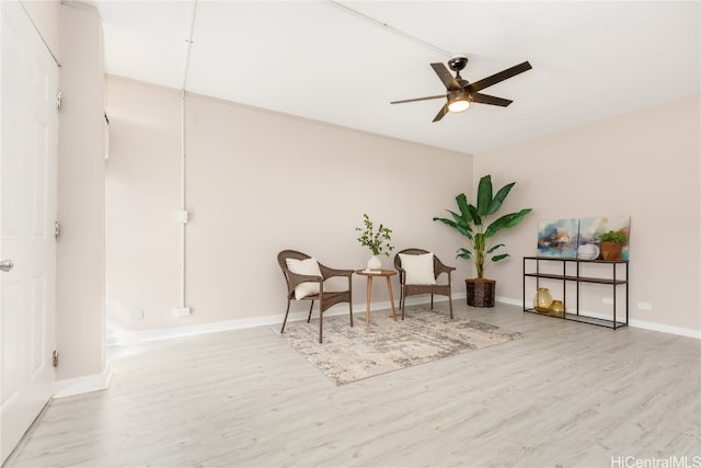 sitting room featuring light hardwood / wood-style flooring and ceiling fan