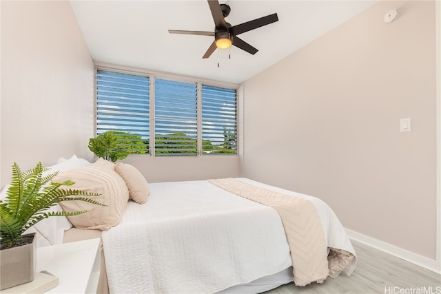 bedroom with ceiling fan and light hardwood / wood-style flooring