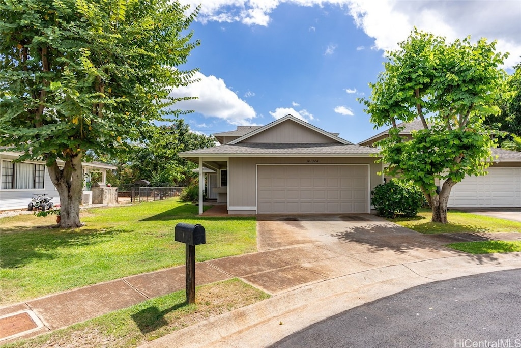 view of front of property featuring a front yard and a garage