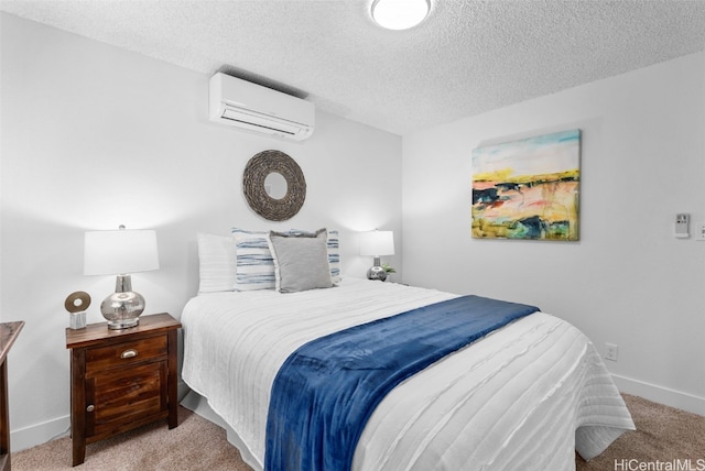 bedroom with light carpet, a textured ceiling, and a wall unit AC