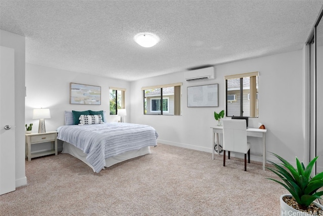 carpeted bedroom featuring an AC wall unit and a textured ceiling