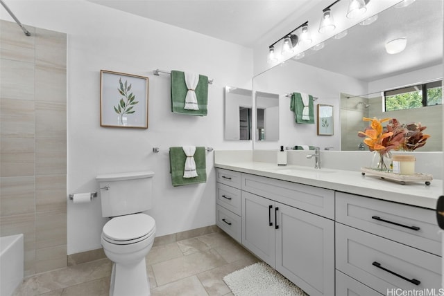 bathroom featuring vanity, toilet, a tile shower, and tile patterned floors