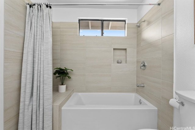 bathroom featuring shower / bath combo with shower curtain and toilet