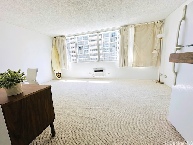 interior space with a textured ceiling and a wall mounted AC