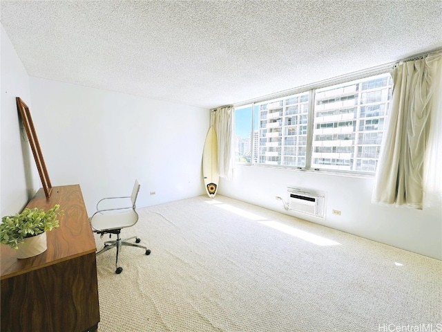 carpeted office space featuring a wall mounted air conditioner and a textured ceiling