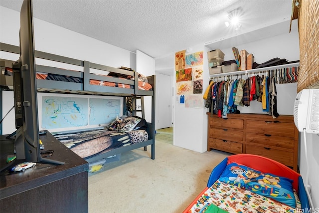 carpeted bedroom featuring a closet and a textured ceiling