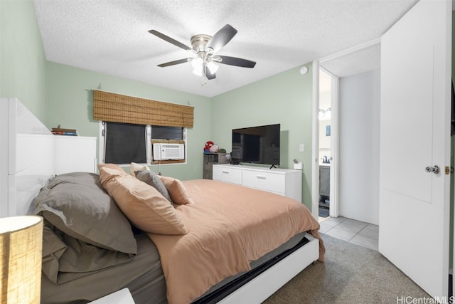 bedroom with ensuite bath, a textured ceiling, cooling unit, ceiling fan, and light carpet