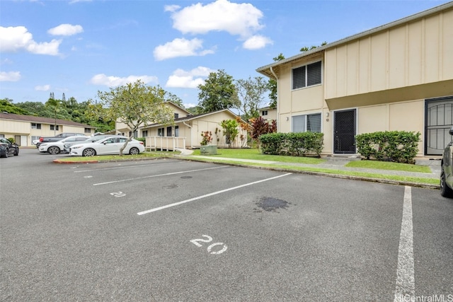 view of car parking featuring a yard