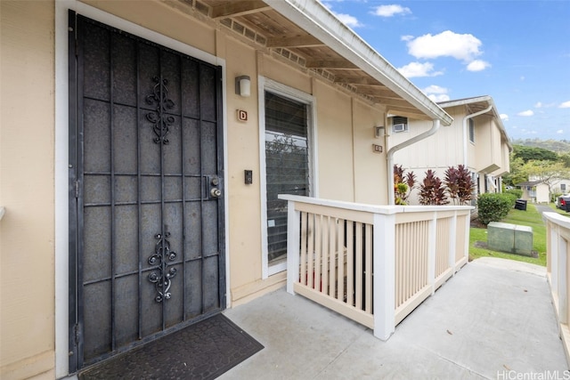 view of exterior entry featuring a porch