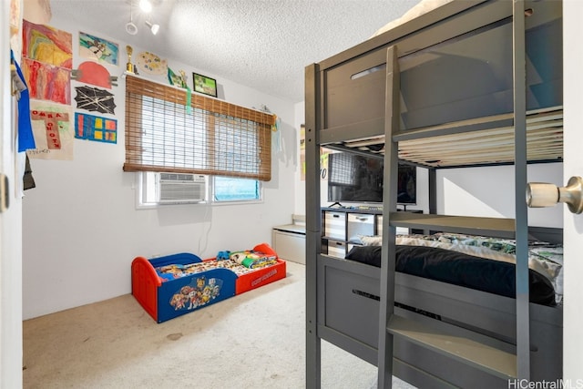 bedroom with a textured ceiling and carpet