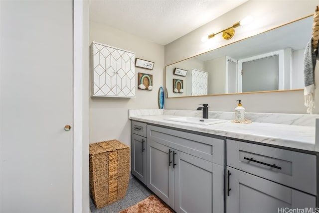 bathroom with vanity and a textured ceiling