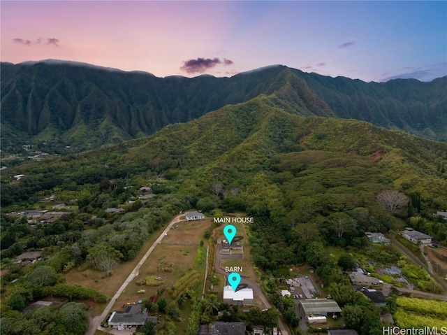 aerial view at dusk featuring a mountain view