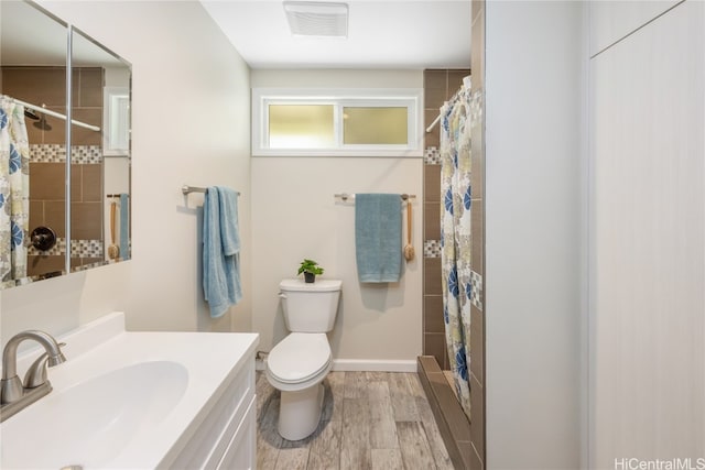 bathroom with toilet, hardwood / wood-style floors, vanity, and a shower with shower curtain