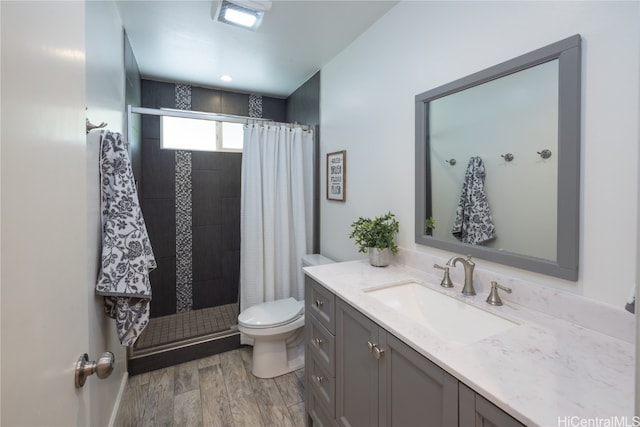 bathroom with vanity, hardwood / wood-style floors, toilet, and walk in shower