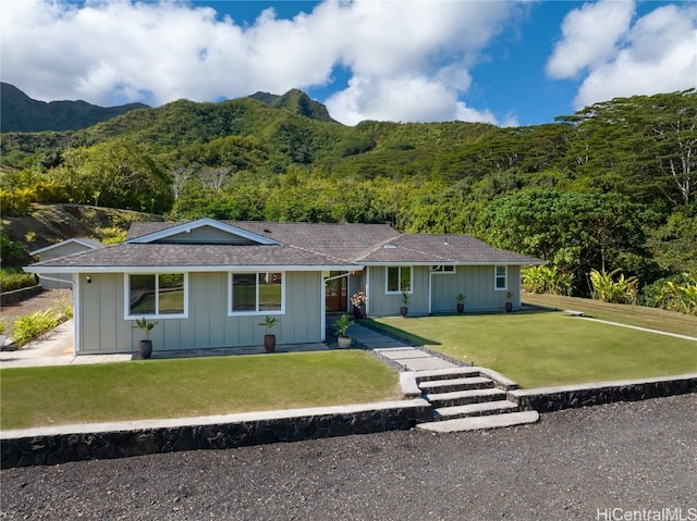 ranch-style house featuring a front yard and a mountain view