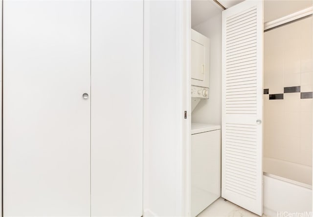 closet with stacked washing maching and dryer