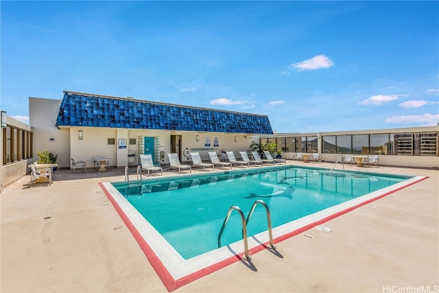 view of swimming pool with a patio