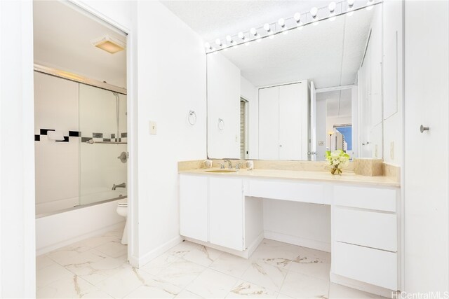 full bathroom featuring vanity, toilet, a textured ceiling, and bath / shower combo with glass door