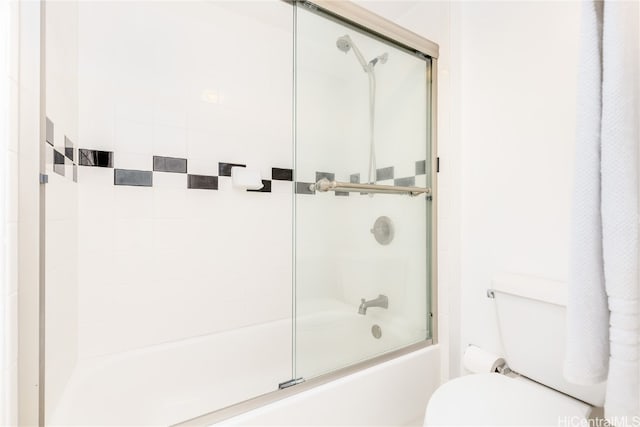 bathroom featuring toilet and enclosed tub / shower combo