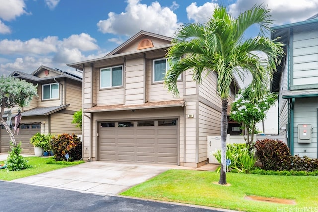 view of front of house featuring a front lawn and a garage