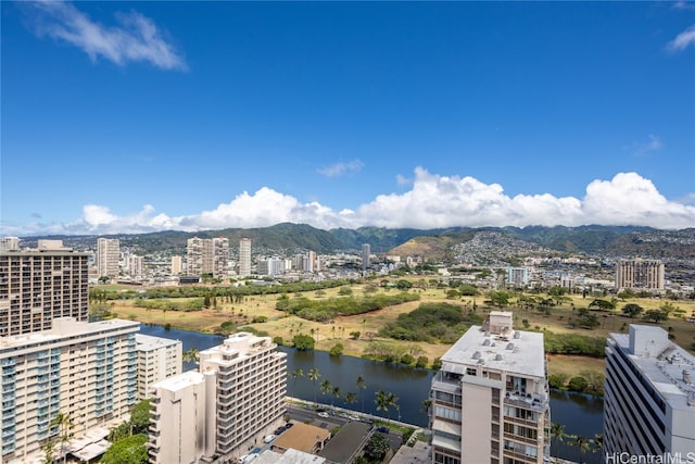 birds eye view of property with a water and mountain view