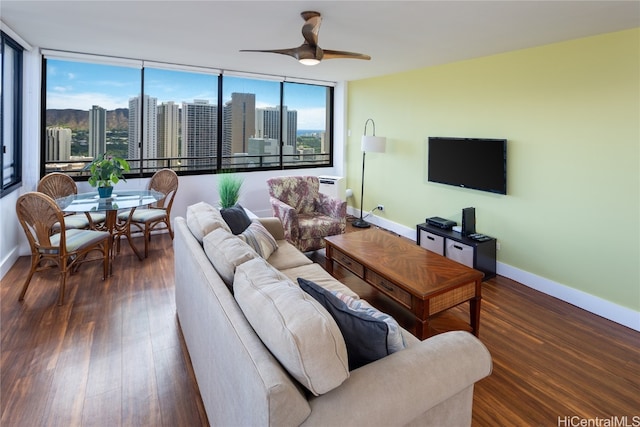 living room with ceiling fan, expansive windows, and dark hardwood / wood-style floors