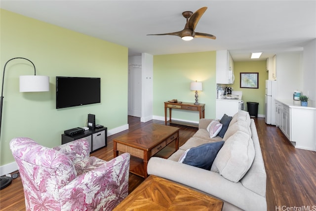 living room featuring ceiling fan and dark hardwood / wood-style flooring