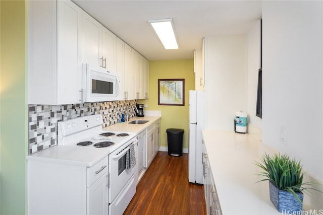 kitchen featuring white cabinets, tasteful backsplash, dark hardwood / wood-style floors, sink, and white appliances