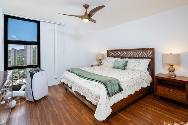 bedroom with ceiling fan and dark hardwood / wood-style floors