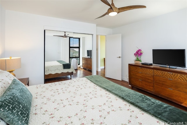 bedroom with a closet, hardwood / wood-style flooring, and ceiling fan