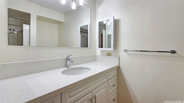 bathroom featuring vanity and a textured ceiling