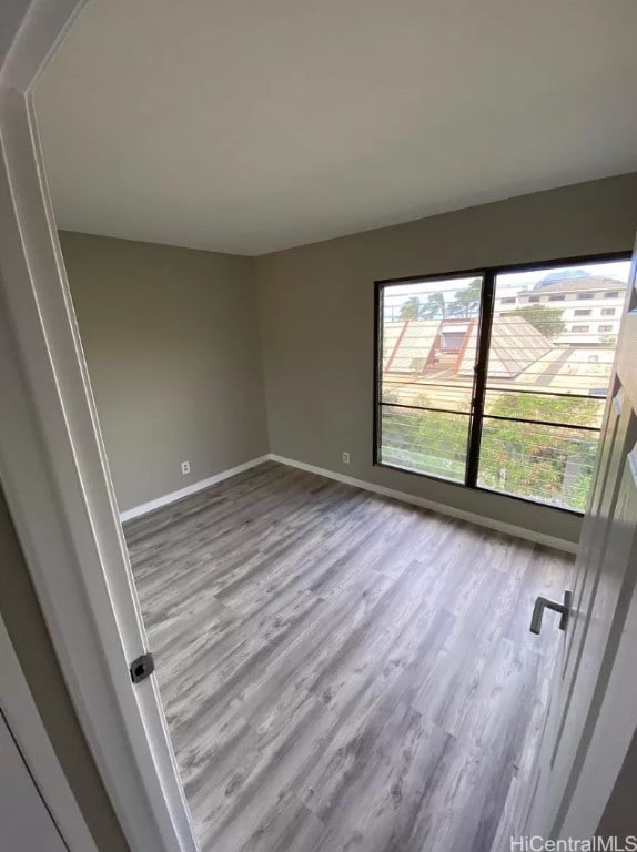 unfurnished room featuring hardwood / wood-style flooring