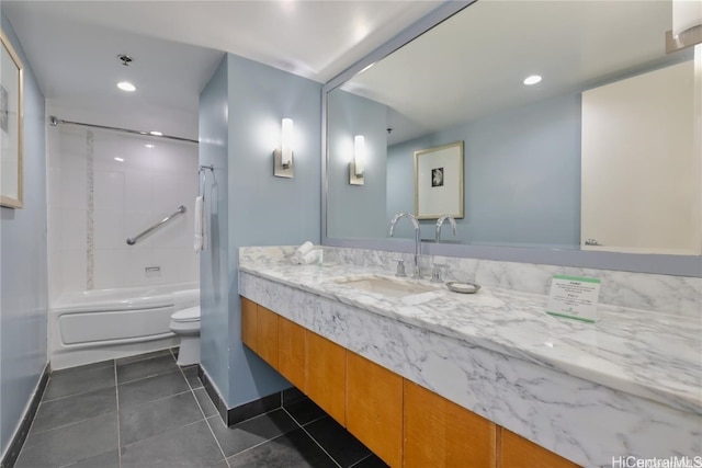 full bathroom featuring toilet, tiled shower / bath, vanity, and tile patterned floors