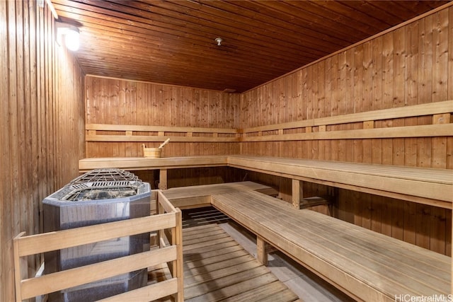 view of sauna / steam room with wooden ceiling and wooden walls