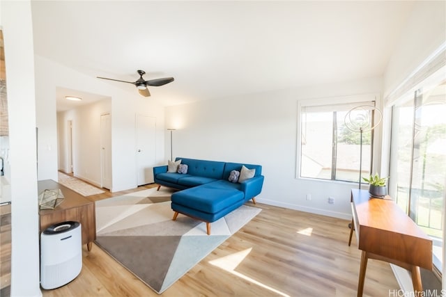 living room featuring light wood-type flooring and ceiling fan