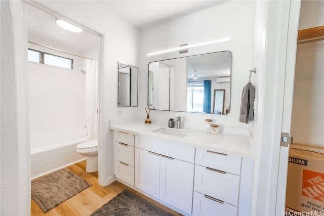 full bathroom with a healthy amount of sunlight, vanity, shower / bath combination with curtain, and toilet