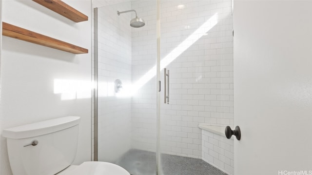 bathroom with toilet and walk in shower