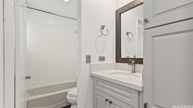 full bathroom featuring bathtub / shower combination, vanity, and toilet