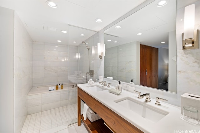 bathroom with vanity, shower with separate bathtub, tile patterned floors, and tile walls