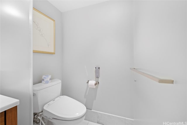 bathroom with vanity, toilet, and tile patterned flooring