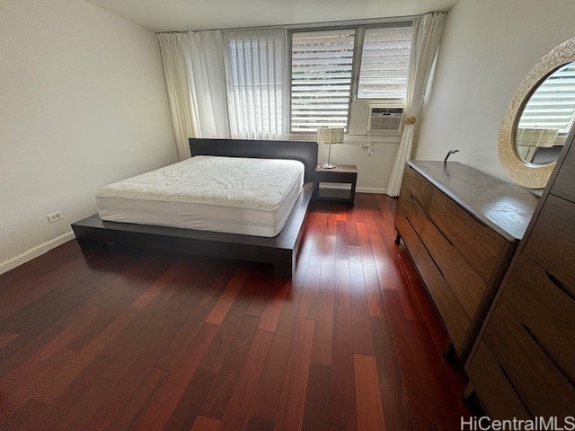 bedroom featuring cooling unit and dark wood-type flooring