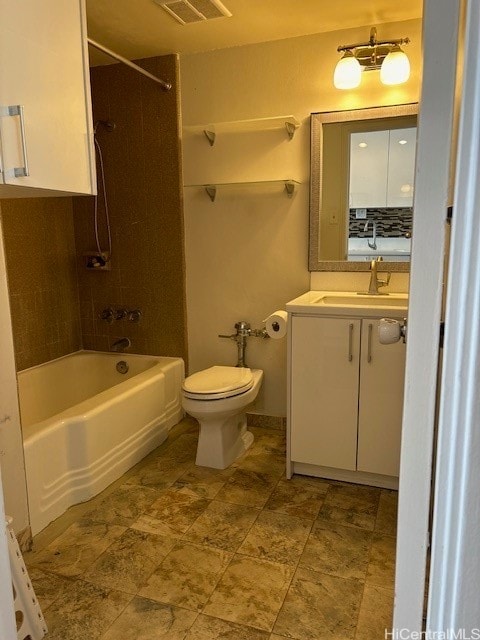 full bathroom with vanity, tiled shower / bath combo, and toilet