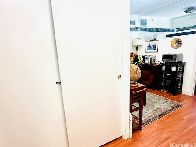 home office with wood-type flooring