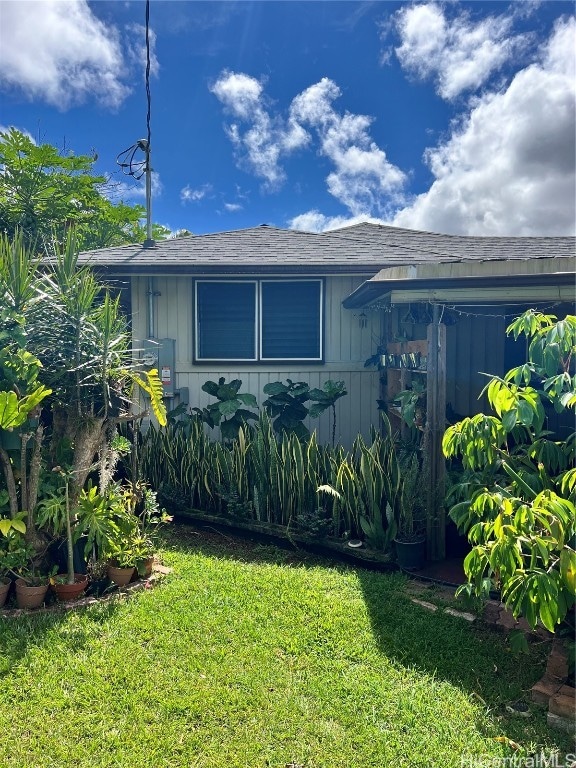 view of side of home featuring a lawn