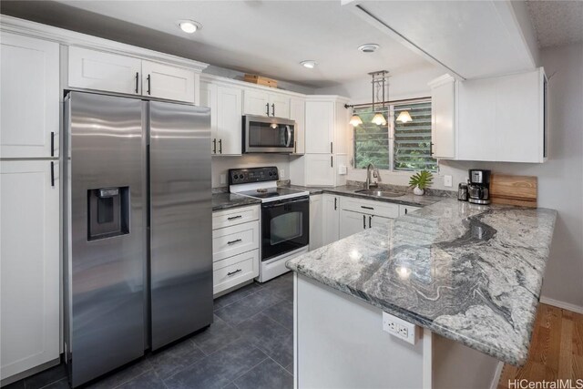 kitchen with kitchen peninsula, white cabinetry, sink, and stainless steel appliances