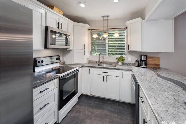 kitchen with light stone countertops, sink, hanging light fixtures, white cabinets, and appliances with stainless steel finishes