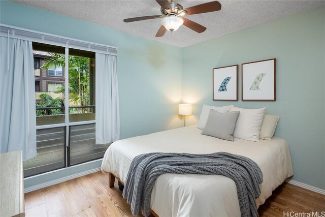 bedroom featuring ceiling fan, a textured ceiling, and hardwood / wood-style flooring