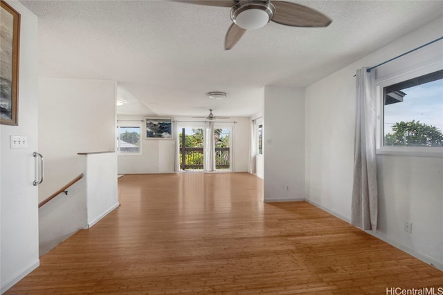 spare room featuring wood-type flooring, a textured ceiling, and ceiling fan