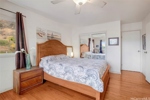 bedroom with ceiling fan, a closet, and light hardwood / wood-style floors