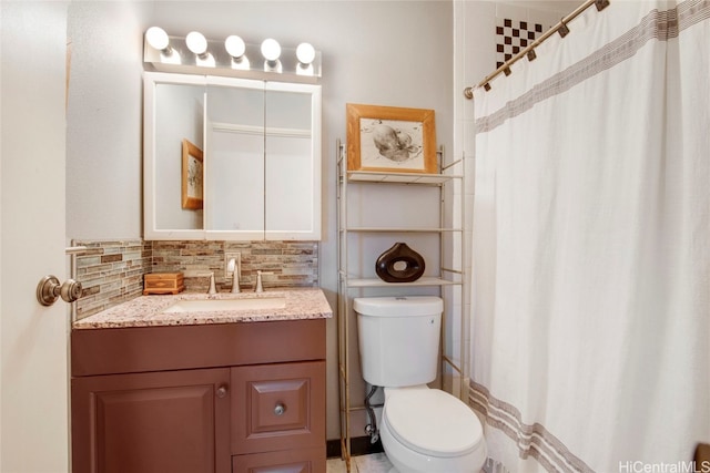 bathroom with decorative backsplash, vanity, toilet, and curtained shower